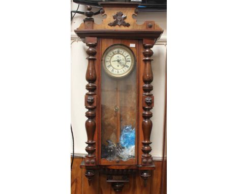 A walnut Vienna style wall clock with cream enamel dial, gold chapter ring, Roman numerals, pendulum and winder, with eagle p