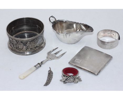 A small collection of assorted silver items including a sauce boat, a bangle and a cigarette case, gross weight of silver ite