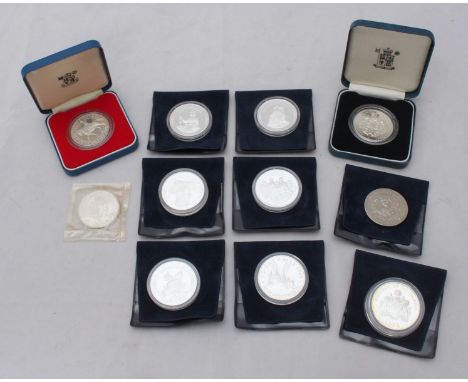 Eleven Commemorative Silver coins including six from 'The Victorian Age,' a 'World at War' Turks and Caicos and HM Queen Moth