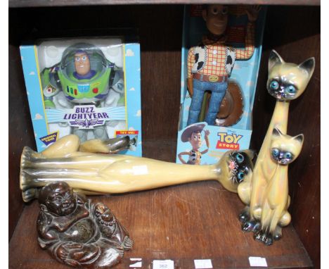 SECTION 39. Two boxed Thinkway figures of 'Woody' and 'Buzz Lightyear' together with two Jema ceramic cats and a carved hardw