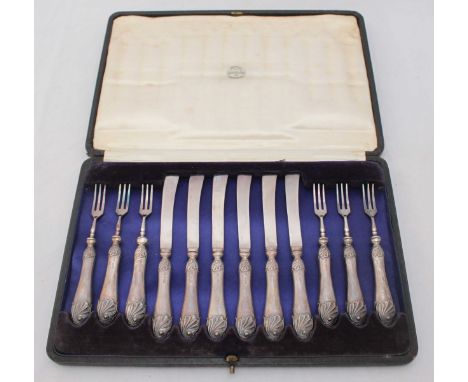 An Edwardian silver six-place dessert set of knives and forks, with shell-capped handles, Sheffield, 1908, in fitted case