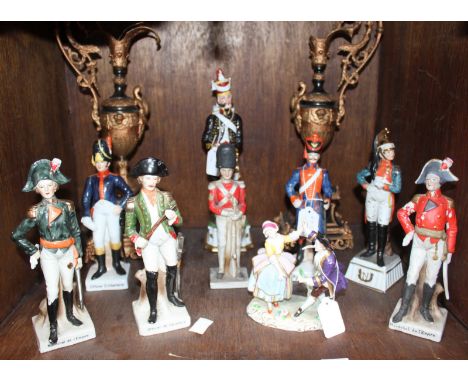 SECTION 33. Eight various ceramic figures of soldiers on stands, together with a porcelain figure-group of a couple dancing a