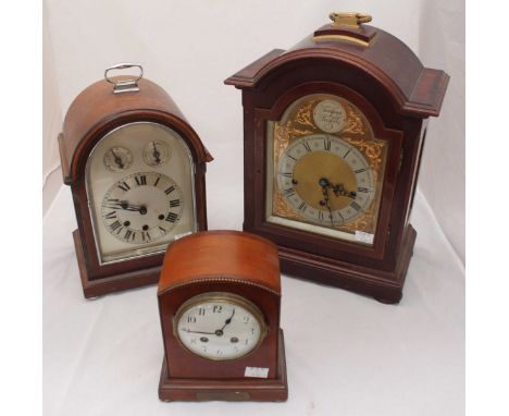 A mahogany cased bracket clock with arched top marked 'Tempus Fugit', silvered dial with Roman numerals and Westminster chime