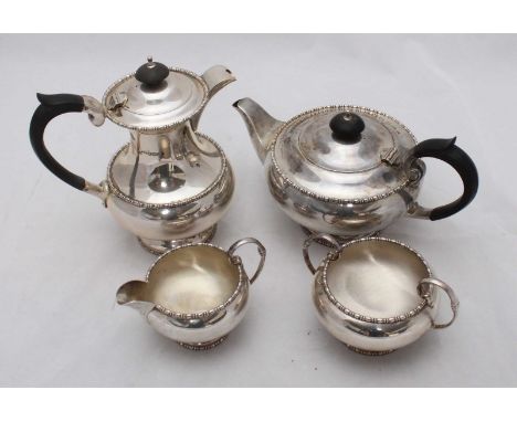 A four-piece silver tea set by Walker and Hall, with beaded decoration and ebonised handles to tea and coffee pots, hallmarke