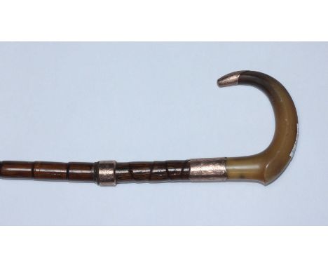 An early 20th century walking cane with horn handle and three 9ct gold mounts, together with tweleve various walking sticks, 