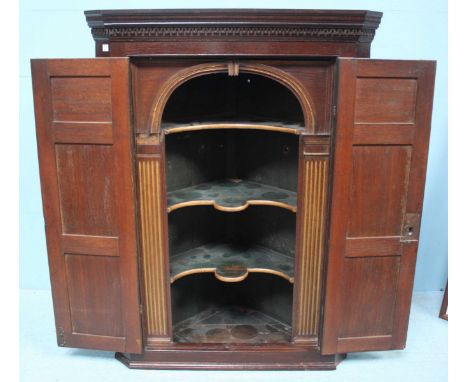 An 18th century stained oak hanging corner cupboard with six fielded panels, an 18th century oak shield-back armchair, a stai