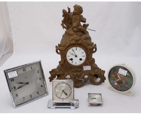 A gilt spelter mantel clock, the white enamel dial with Roman numerals denoting hours, surmounted with a figure of a putti an