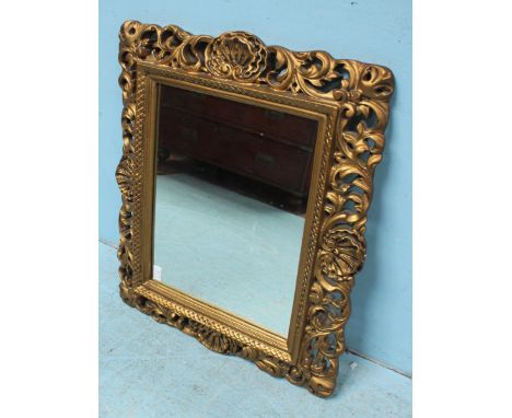 A rectangular wall hanging mirror, in ornately pierced and scrolled gilt frame. 65 x 54cm, together with a stained mahogany f