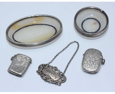 A silver vesta case with engraved foliate design, Birmingham, 1898, maker's mark of EV Pledge & Son, together with another si