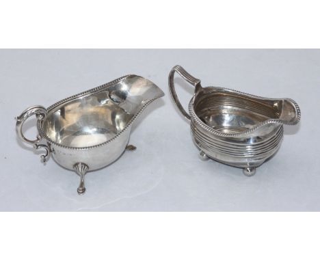 A silver cream jug, London 1809?, maker's marks rubbed, together with a silver sauce boat, Birmingham, 1937, maker's mark of 