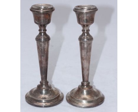 A pair of silver candlesticks by A T Cannon Ltd, hallmarked Birmingham, 1968. 21cm high.