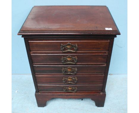 A mahogany music cabinet comprising of five drawers, each with brass handles and raised on shaped bracket feet. 63cm high.