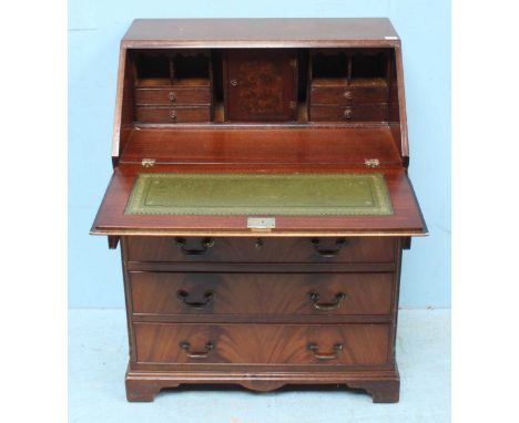 A mahogany bureau, the fall-front opening to reveal a fitted interior with gilt-tooled green leather scribe, drawers and pige