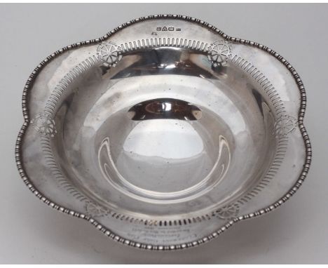 A silver lobed circular dish with pierced decoration to the border, engraved inscription, Chester, 1924, maker's mark of Bark