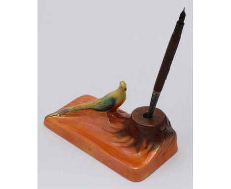 A Carlton Ware pen holder and stand modelled with an exotic bird and lustre decoration, 18cm wide