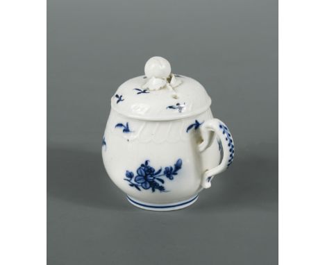 A Tournai blue and white baluster custard cup and cover, circa 1780, decorated with floral sprays within spirally moulded bor