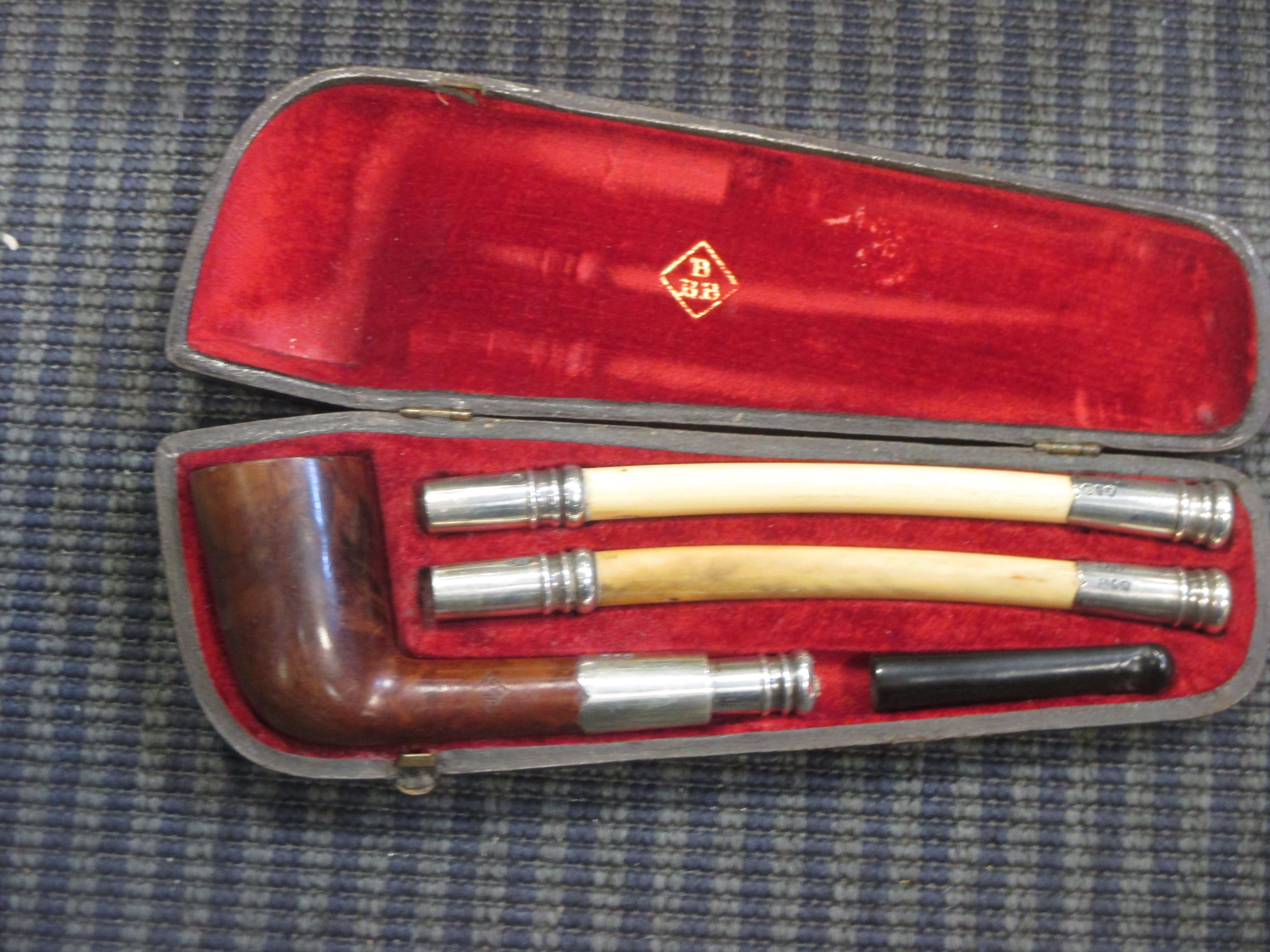 A cased pipe with silver fittings and interchangeable stems together with another in Cheffins
