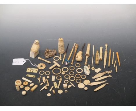 A collection of vintage ivory and bone items including two stanhopes, cigarette holders, bobbins, a netsuke etc  