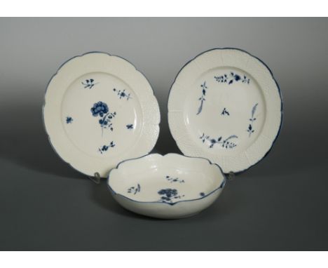 A pair of Chantilly porcelain blue and white plates, circa 1750, decorated to the centre with scattered sprigs within moulded