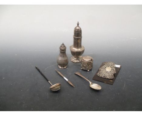 A collection of silverware including a sugar caster, pepperette, mustard, teaspoon, toddy ladle, plumb weight and silver and 