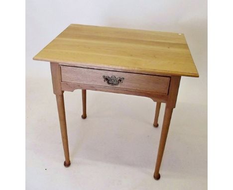 A light oak side table with drawer on pad feet
