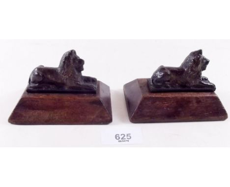 A pair of Victorian miniature bronze lions on wooden bases - 10cm