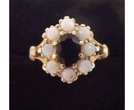 A 15 carat gold opal and sapphire cluster ring 