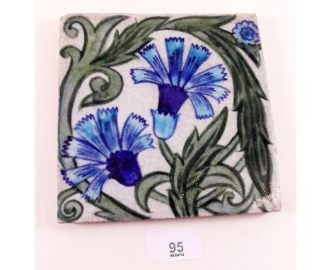 A tile by William De Morgan painted carnations 