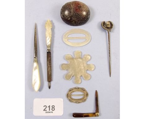 A mother of pearl counter, manicure items, cherub stick pin, miniature penknife etc.