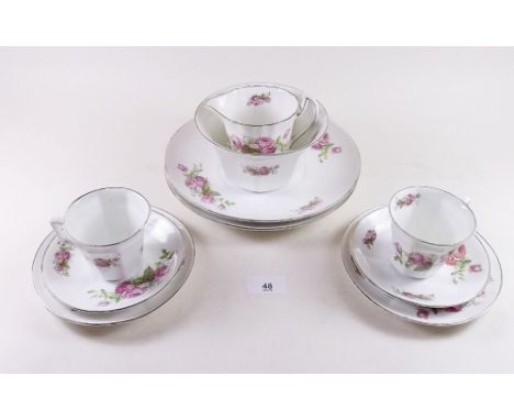 A 1920's rose printed teaset comprising: ten cups and saucers and twelve tea plates