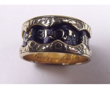 An early 19th century 18 carat gold and black enamel mourning ring 