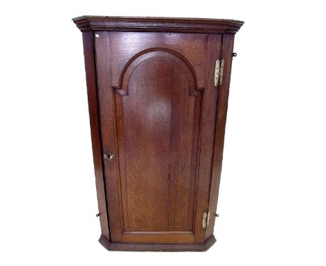 A 19th century oak corner cabinet with arch panelled door, painted oil portrait after Gainsborough to interior door 