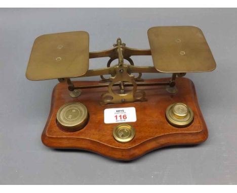 Set of vintage brass postal scales and weights, on polished mahogany base 