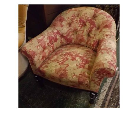 Floral upholstered button back armchair, raised on fluted legs and brass castors 