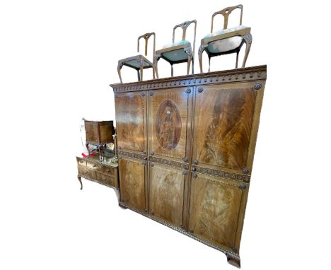 Early 20th Century carved mahogany six piece bedroom suite comprising triple door wardrobe, 214cm by 191cm by 57cm, five draw