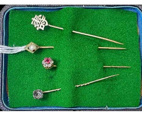 Four yellow gold stick pins.