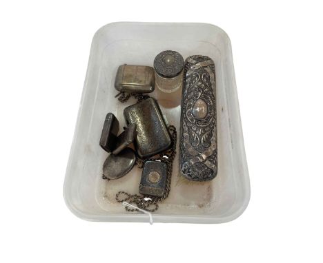 Silver cigarette case, four silver vestas, locket and chain, silver backed brush and toilet bottle.