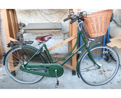 A contemporary Pashley, Stratford upon Avon ladies bicycle with handlebar mounted basket, Lumotec headlamp and Brooks riding 