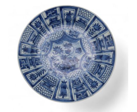 A Chinese kraak style blue and white plate, decorated with alternating diaper panels and flowers, possibly Kangxi period Cond
