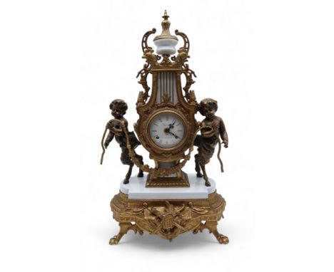 An Italian Imperial clock, mounted with cherubs on a white enamel base Condition Report:Available upon request