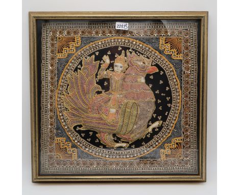 A framed Thai embroidered tapestry panel, depicting a figure and an animal Condition Report:Available upon request