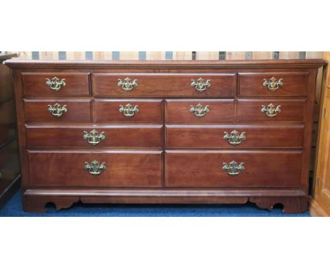 A 20th century mahogany bank of drawers with brass drawer pulls on bracket feet, 81cm high x 157cm wide x 46cm deep Condition