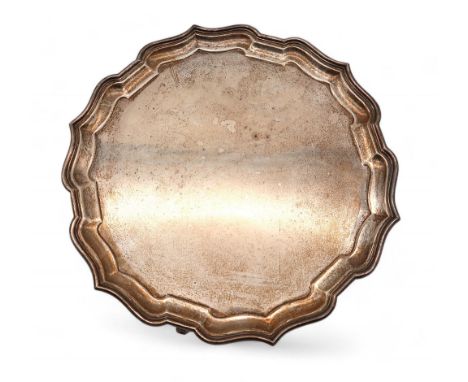 A George V silver salver, by Adie Brothers Ltd, Birmingham 1931, with a chippendale pie crust rim, on three scroll feet, 30cm