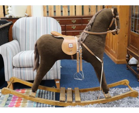 A contemporary Mama's &amp; Papa's child's rocking horse with leather bridle and saddle on wooden base, 101cm high x 142cm lo