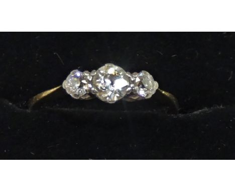 A gold and diamond three stone ring, A gold and diamond three stone ring, claw set with old cut brilliant stones, approximate