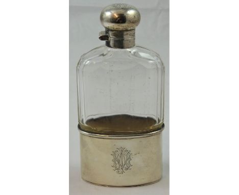 A silver and glass hip flask, London 1919, the faceted glass body with twist silver cap and pull off lower section, monogram,