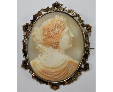 A Victorian gold mounted Bacchanalian lady, with pearl necklace, within a scroll frame, 7 x 5.5 cm. 