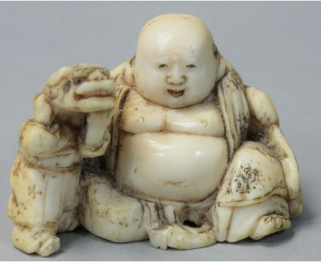 A Japanese Ivory Netsuke, carved with a fat man by a small man with an animal on his back, signed, height 3 cm. 