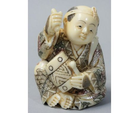 A Japanese Ivory Netsuke, carved and painted as a drummer, signed, height 5.5 cm. 