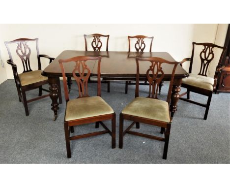 A Victorian mahogany extending dining table and chairs, with thumb nail edge, raised on turned legs with brass castors, with 